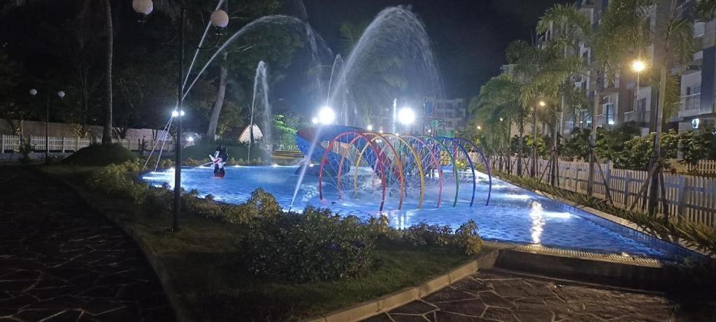 a water fountain in a park at night at Santorini Blue Sapphire - Luxury 3BR Theme Park Resort Apartment - Negombo in Negombo