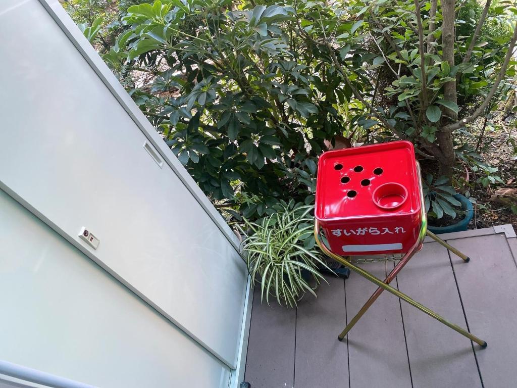 a red chair sitting on the side of a house at Kawaramachi Station · home - Vacation STAY 37891v in Takamatsu