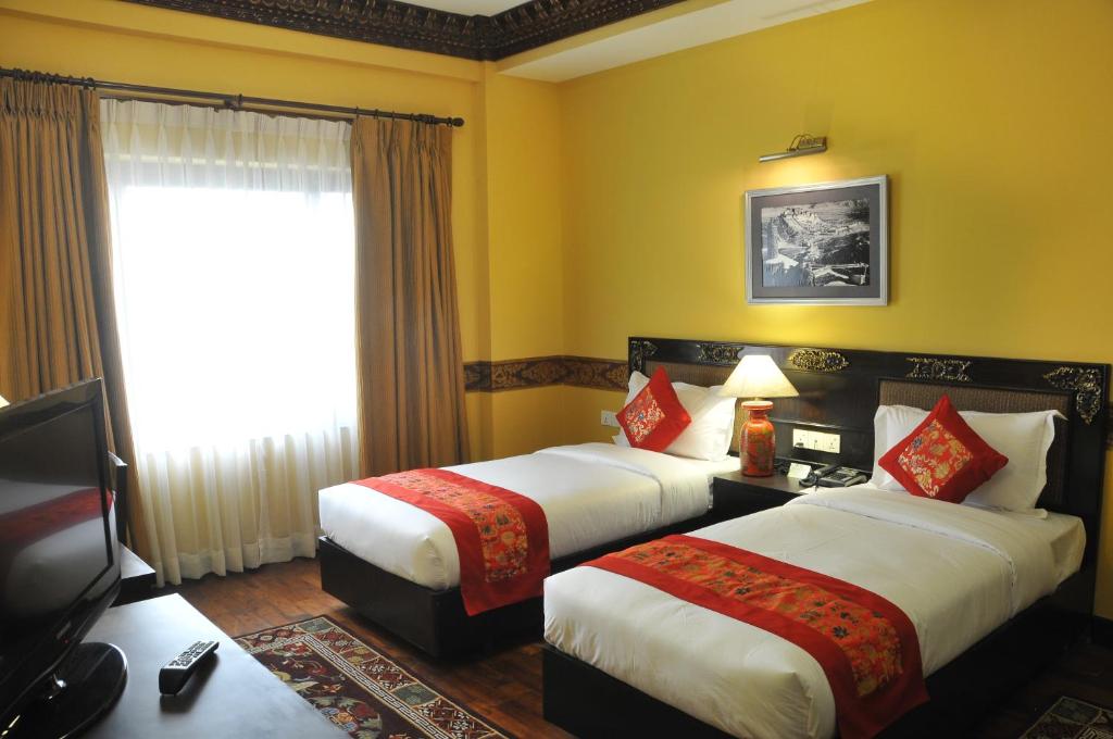 Letto o letti in una camera di Hotel Tibet International