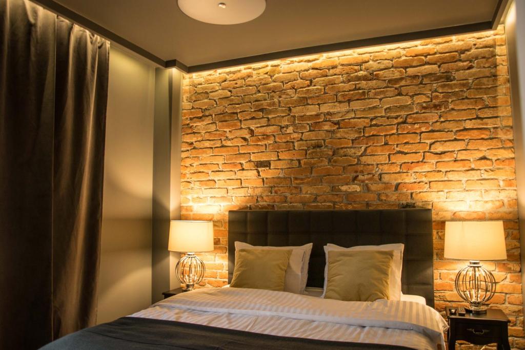 Posteľ alebo postele v izbe v ubytovaní Uniejów Apartments