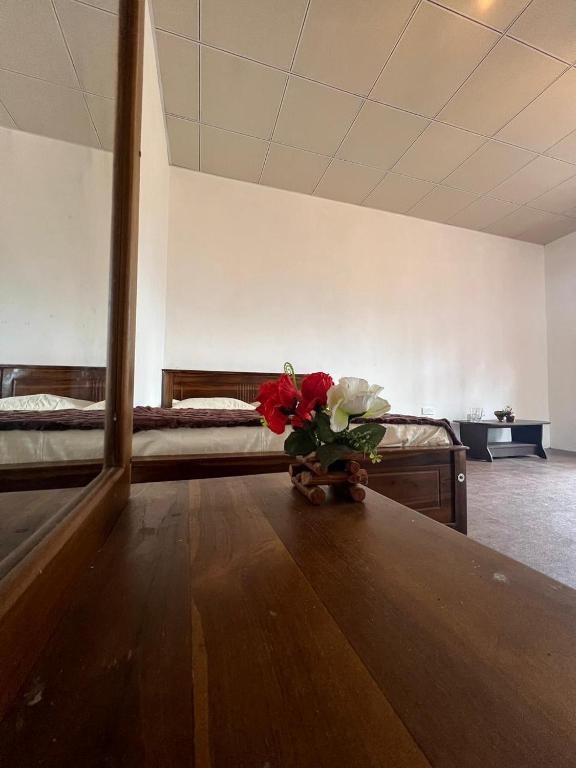 a vase of flowers sitting on a table in a room at The Paradise in Kumbalwela