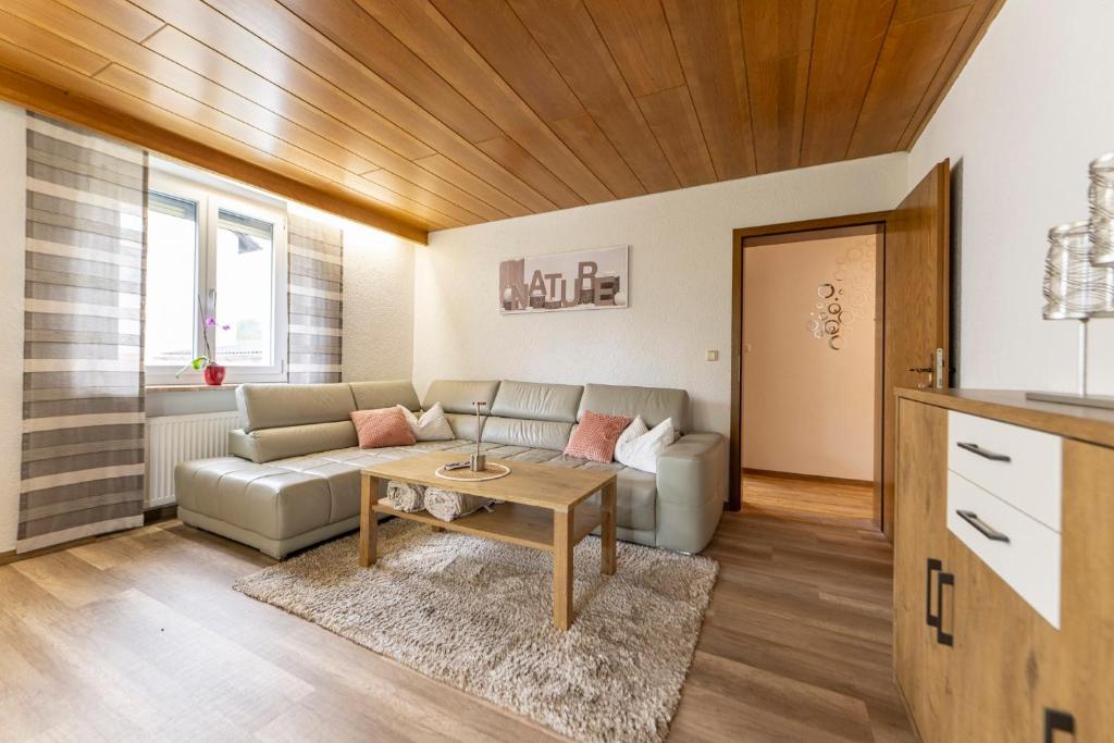 a living room with a couch and a table at Ferienwohnung Putzer in Moosbach