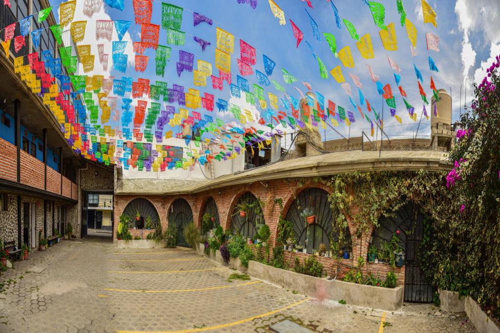 a building with a bunch of flags hanging from the ceiling at OYO Casa Vieja,Ciudad Serdán,Museo La Magnolia in Ciudad Serdán
