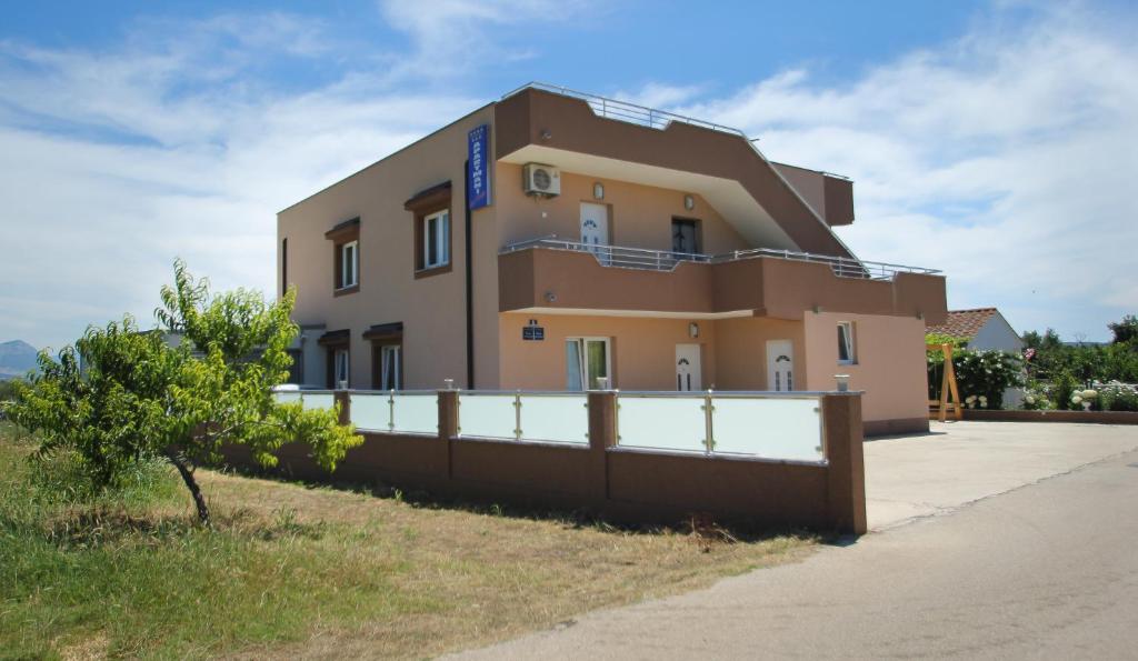 un edificio con una recinzione di fronte di Ana & Marija a Kaštela (Castelli)