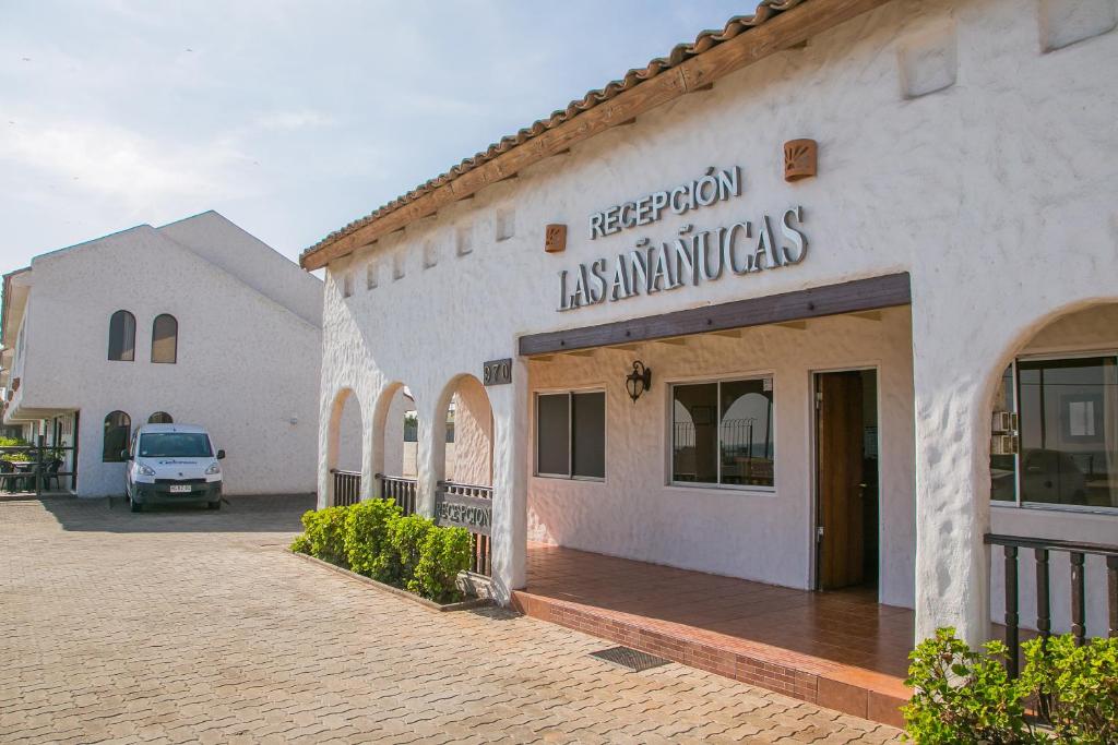a building with a sign on the side of it at Cabañas Las Añañucas II in La Serena