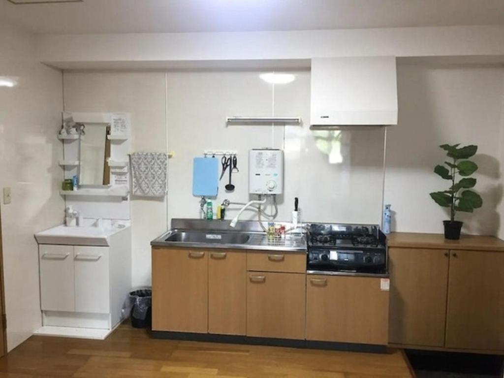 a kitchen with a sink and a stove at Maison dEssence - Vacation STAY 52767v in Izu