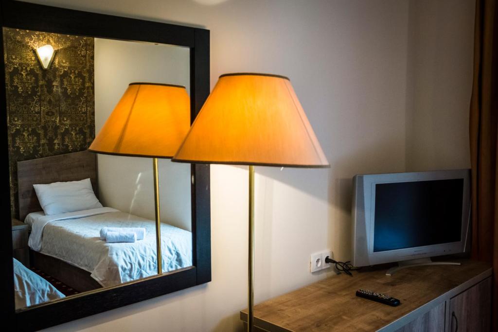 Postel nebo postele na pokoji v ubytování Orange Hotel