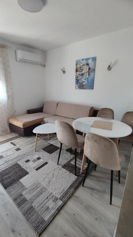a living room with two tables and a couch at Vaske in Bar