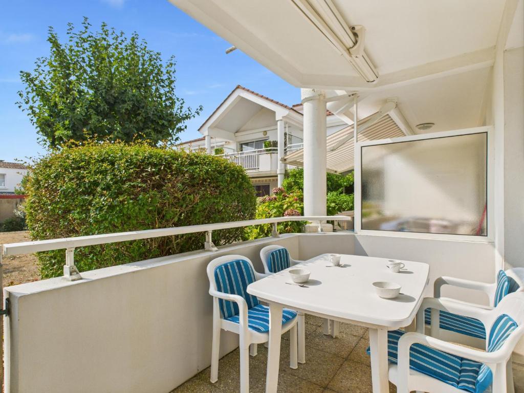 une table blanche et des chaises sur un balcon dans l'établissement 400m de la Grande plage, 2 adultes 2 enfants, à Saint-Gilles-Croix-de-Vie