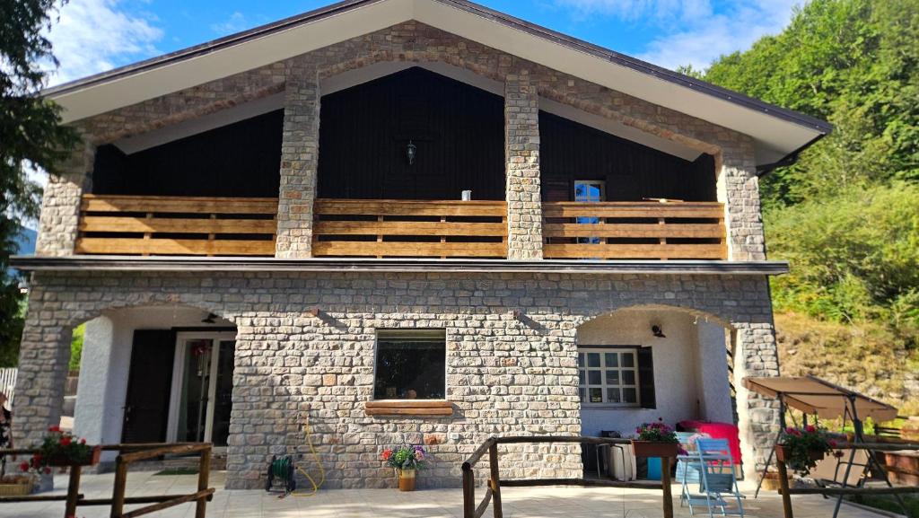 a house with a balcony on top of it at Chalet del Lago Laceno in Villaggio Laceno