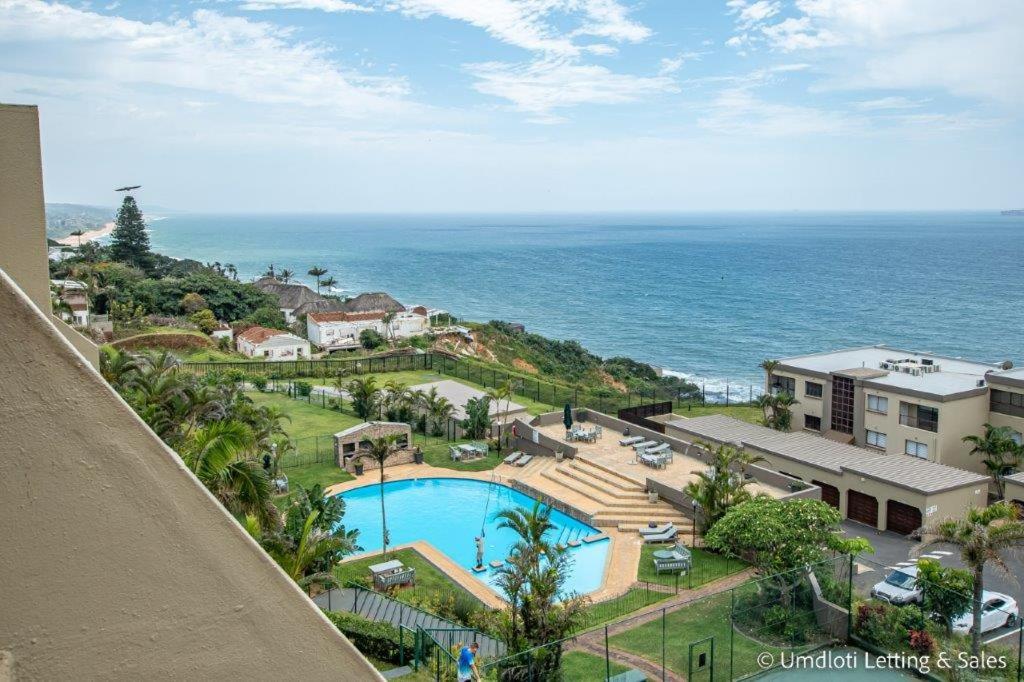 an ocean view from the balcony of a resort with a swimming pool at C302 SURFSIDE in Umdloti