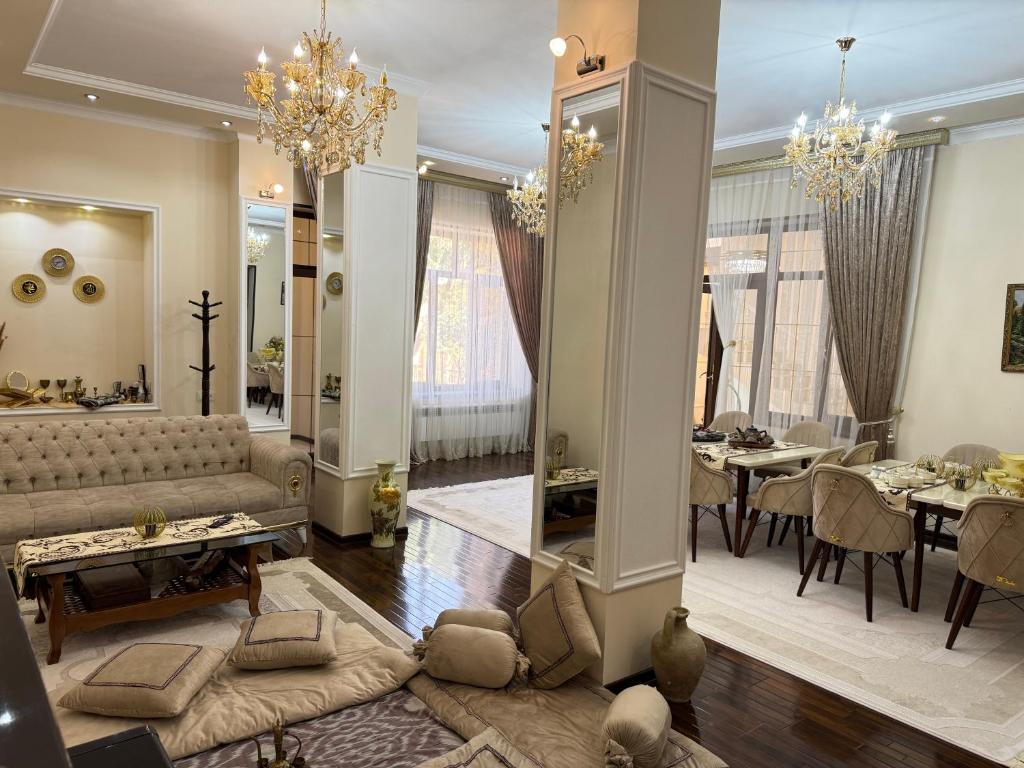 a living room with a couch and a dining room at Feruza guest house in Samarkand