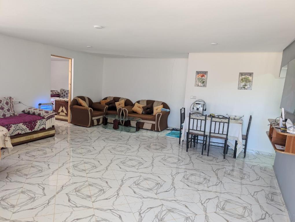 a living room with couches and a table at Guesthouse Skhirat in Skhirat