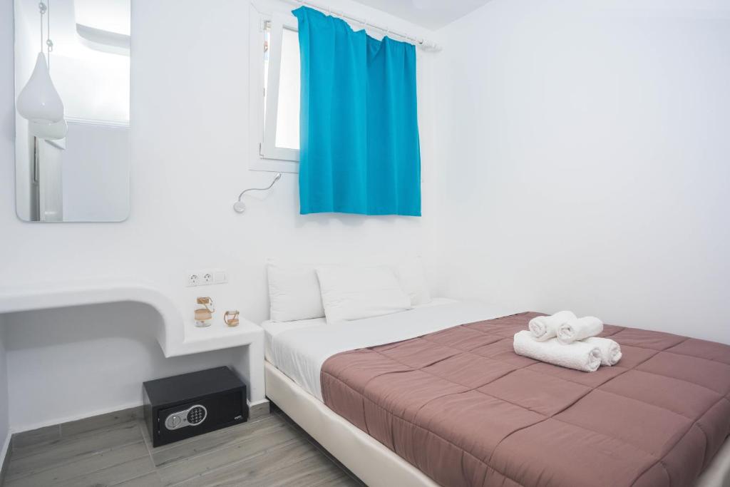 a bedroom with a bed with a towel on it at Depis suites in Naxos Chora