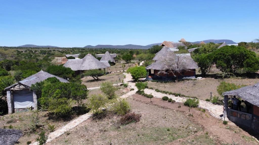 an aerial view of a village with huts at Masai Mara Explore Camp in Narok