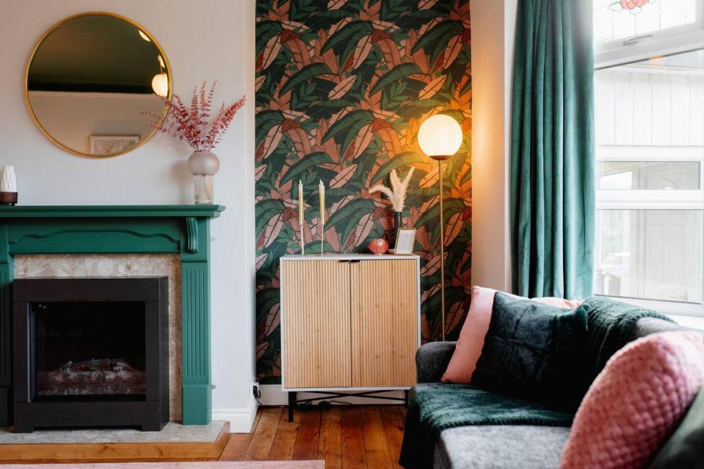 a living room with a fireplace and a mirror at Above Rubies- Bowling Terrace, Dog Friendly, Walks in Skipton