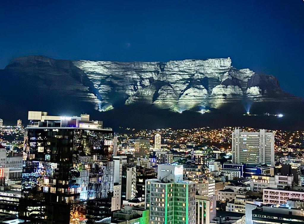 a view of the table mountain in cape town at night at Urban Elephant 16 On Bree in Cape Town