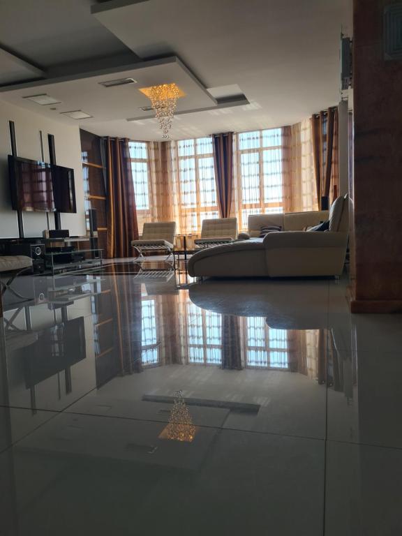 a living room with a couch and chairs on the floor at Business Apart Arkadia in Odesa