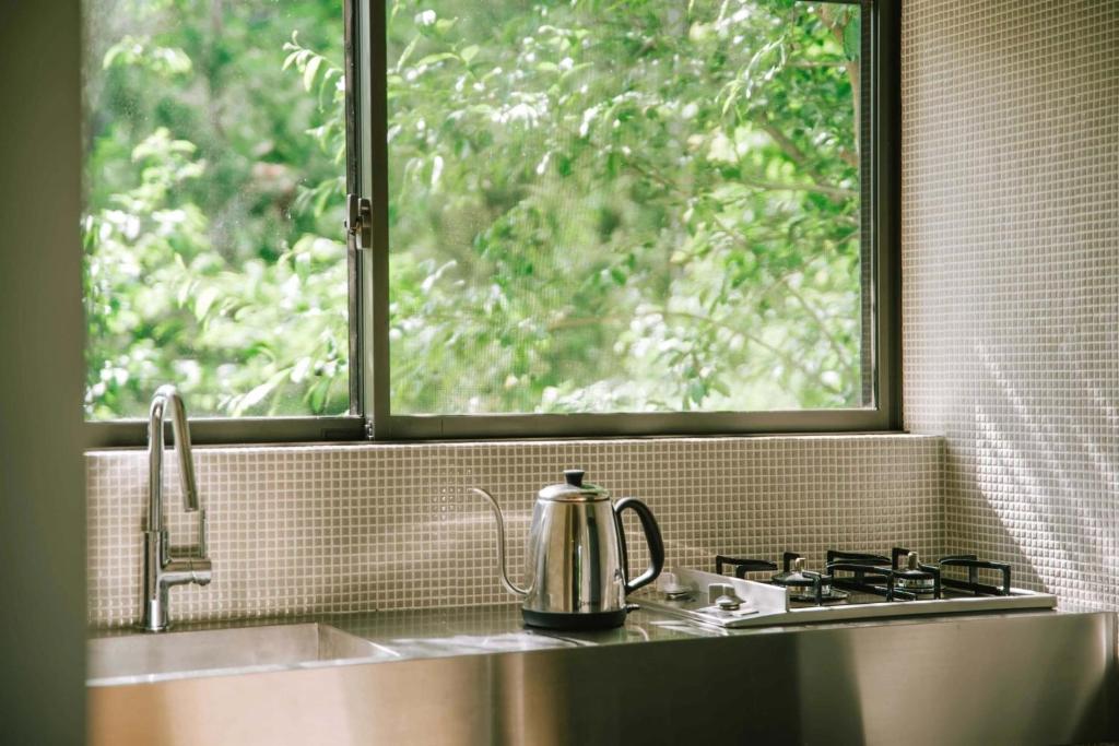 a tea kettle sitting on a kitchen sink with a window at THEATER 1 - Vacation STAY 40857v in Motojuku
