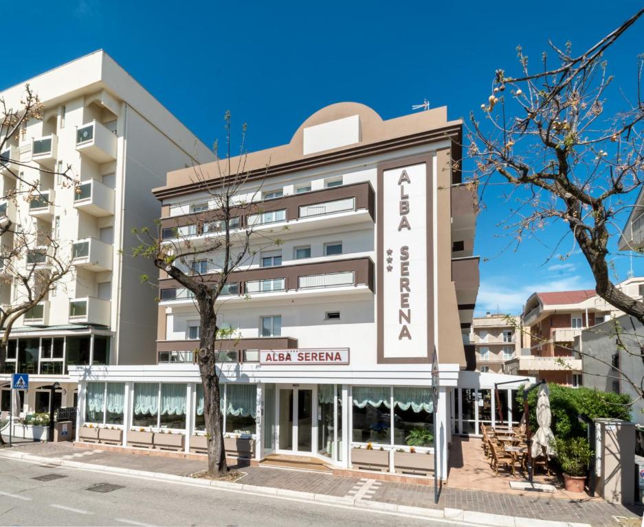 a building with a sign that reads first season at Hotel Alba Serena in Misano Adriatico
