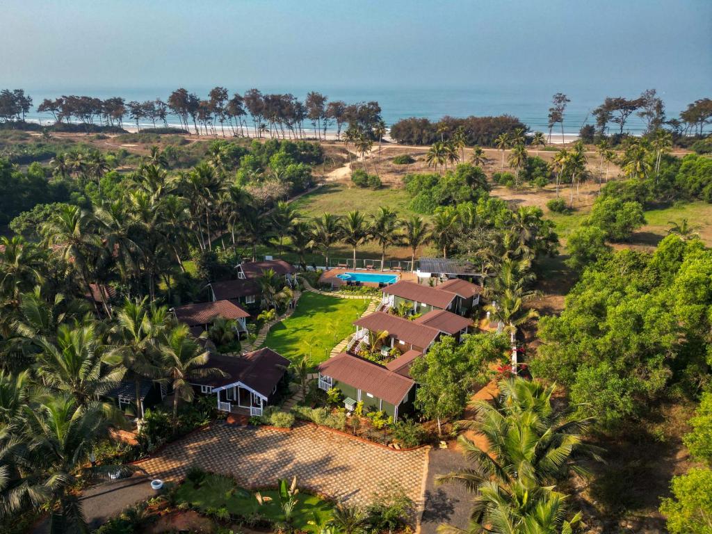 an aerial view of a resort with palm trees and the ocean at Zen By The Sea in Betalbatim