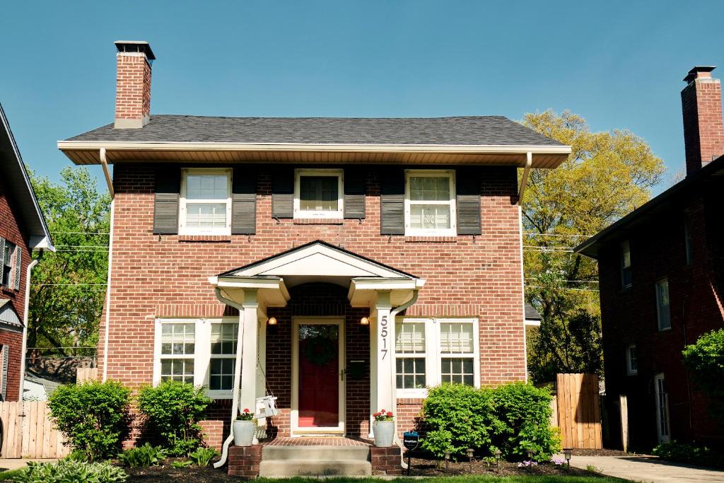 a red brick house with a red door at Boston Manor in Indianapolis