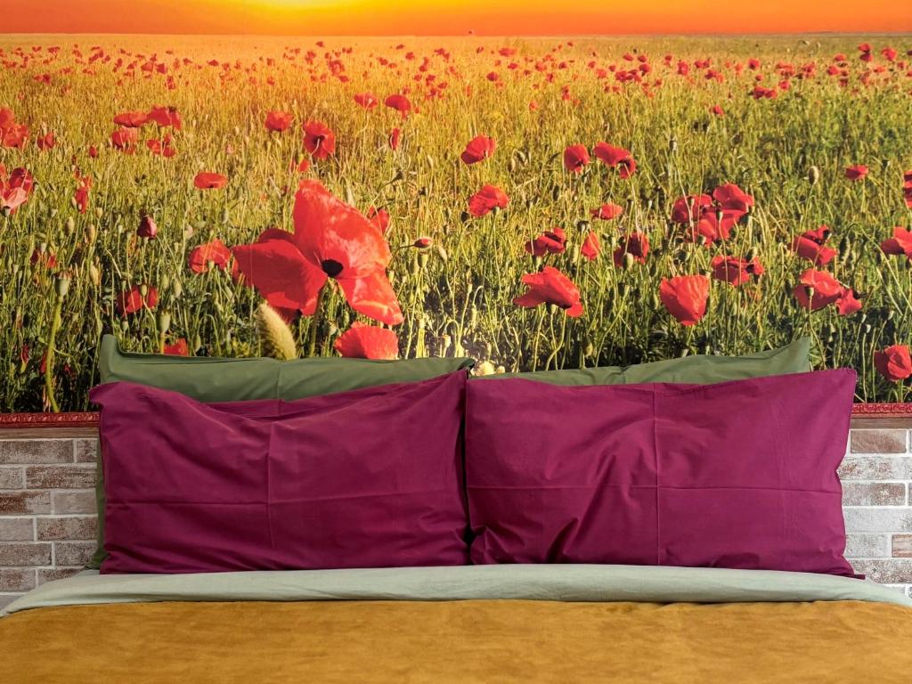 a bed in front of a field of red poppies at BioBenessere Eco-B&B -Adults Only- Moto&Bike Parking in Arezzo