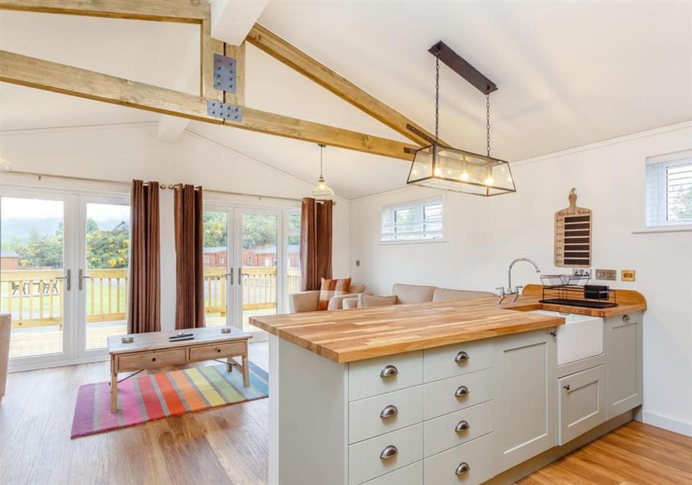 a kitchen with white cabinets and a table in a room at Sanctuary Pathfinder Lodge in Fort Augustus