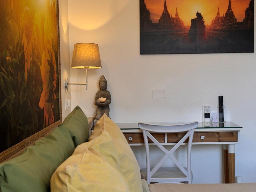 a living room with a couch and a desk at BioBenessere Eco-B&B -Adults Only- Moto&Bike Parking in Arezzo