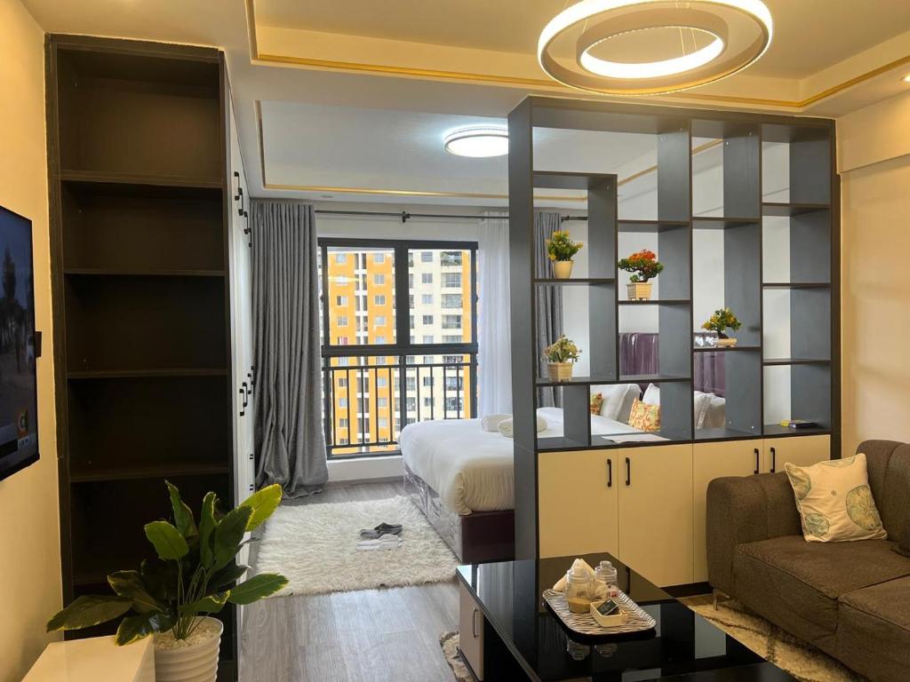 a bedroom with a bed and a living room at Ace one bedroom in kileleshwa in Nairobi