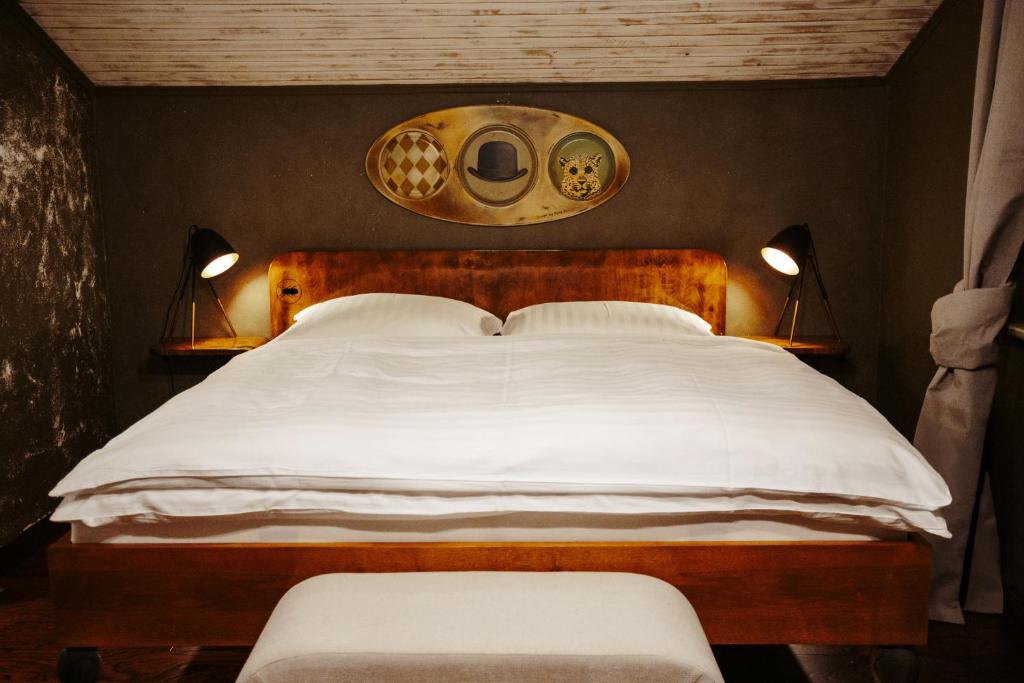 a bedroom with a large bed with two lamps at Pepin Stay in Topoľčany