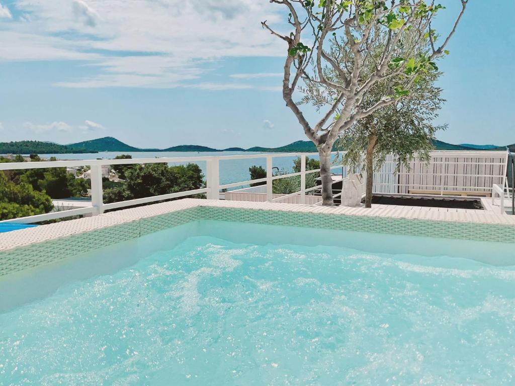 a swimming pool with a view of the water at Vila Amara - Resort Vita in Drage