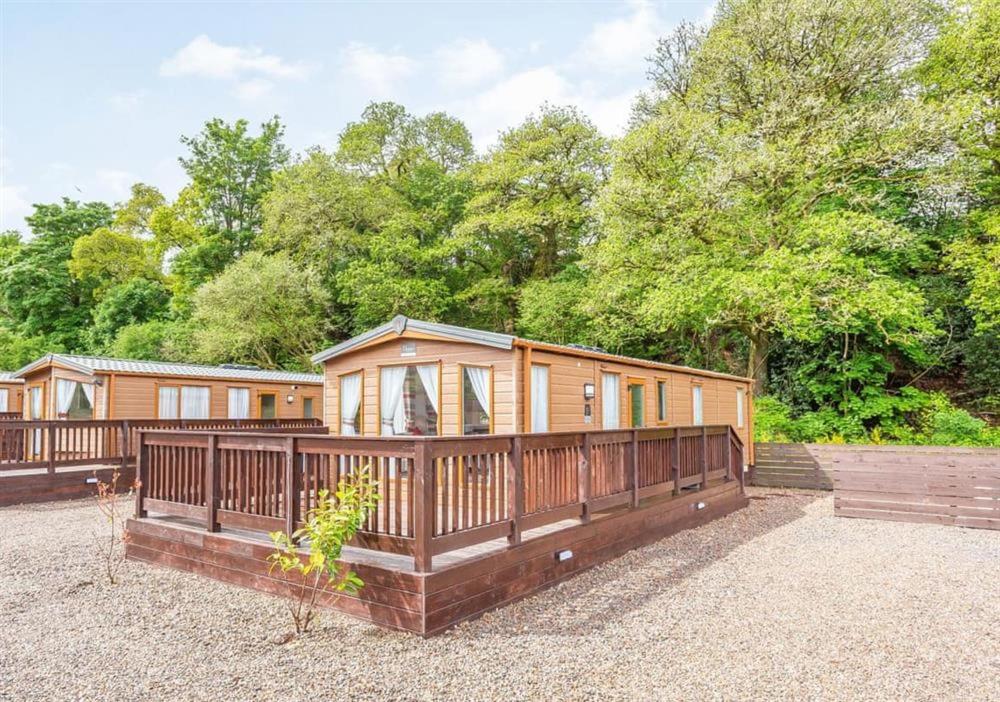 a modular home with a porch and a deck at The Ness Hot tub Lodge in Fort Augustus
