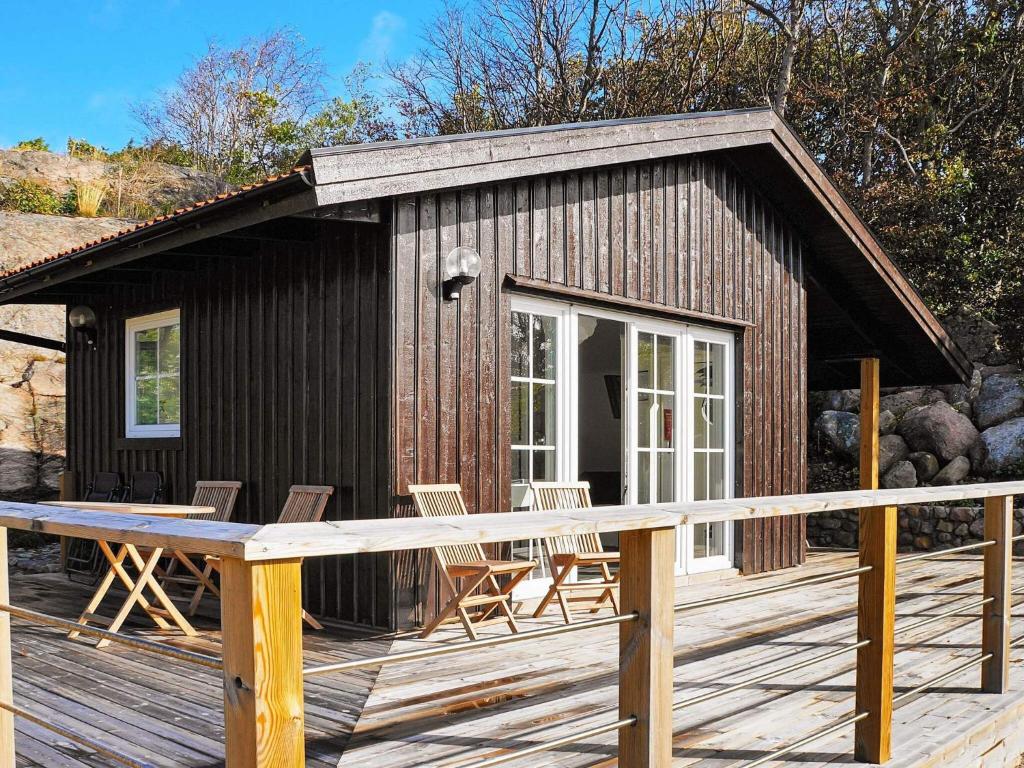 a small cabin with chairs on a wooden deck at 4 person holiday home in Skärhamn-By Traum in Skärhamn