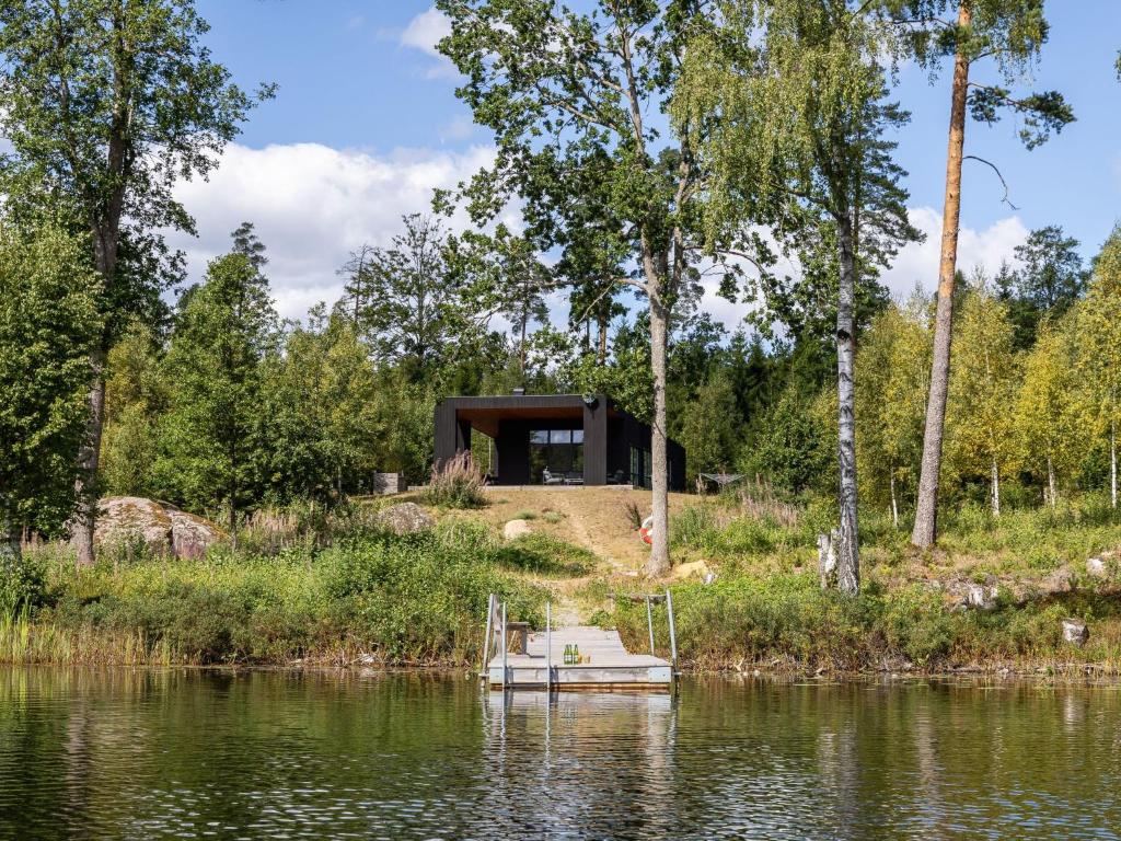 a house on the shore of a lake at Holiday Home Paradiset by Interhome in Holmsjö