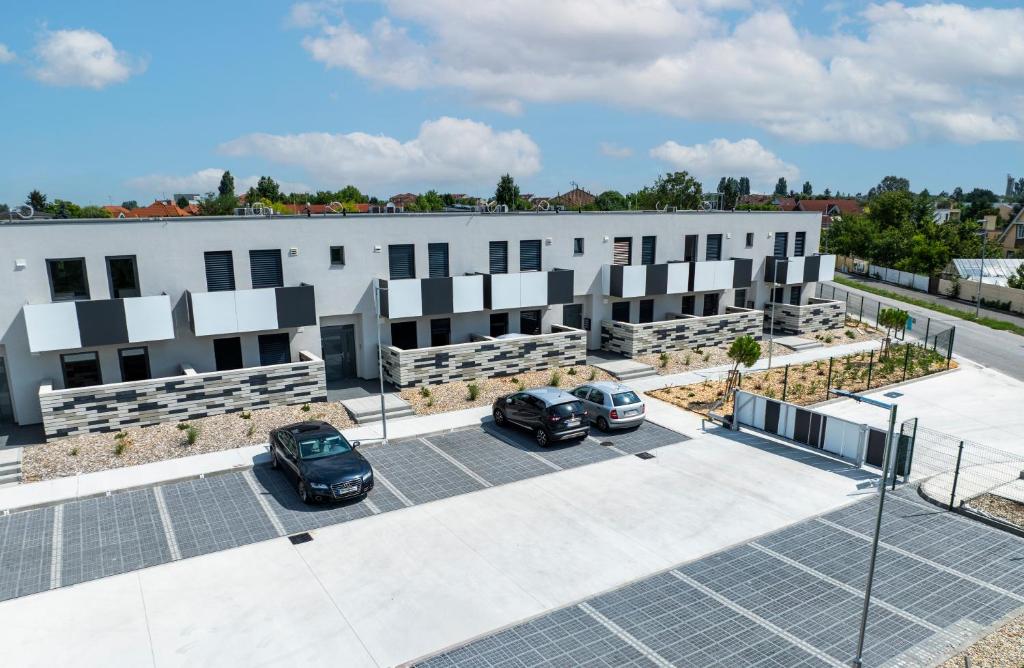 a building with solar panels in a parking lot at DUO Residences in Dunajská Streda