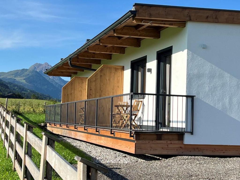 a house with a balcony and a fence at Apartment Appartement Erwin-2 by Interhome in Kirchberg in Tirol