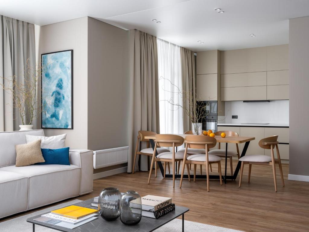 a living room with a couch and a table at A27 Apartments in Almaty