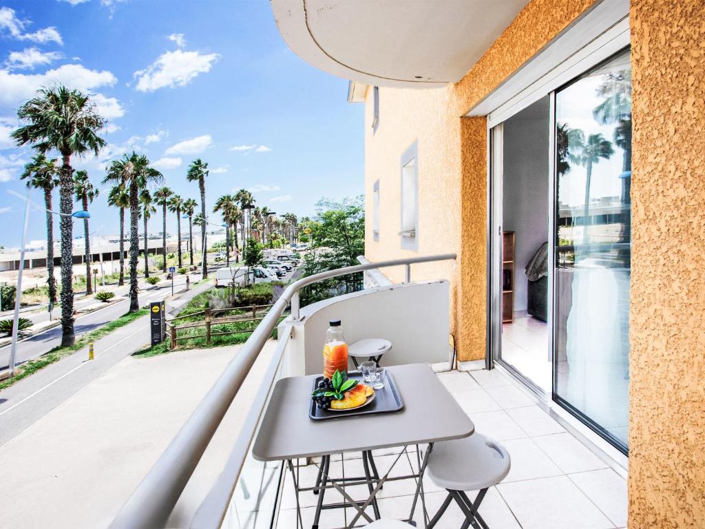 a balcony with a table and chairs and a view of a street at Apartment Atrium by Interhome in Caves