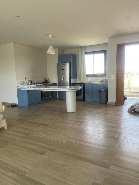 an empty living room with a kitchen and a counter at Almaza Bay in Alexandria