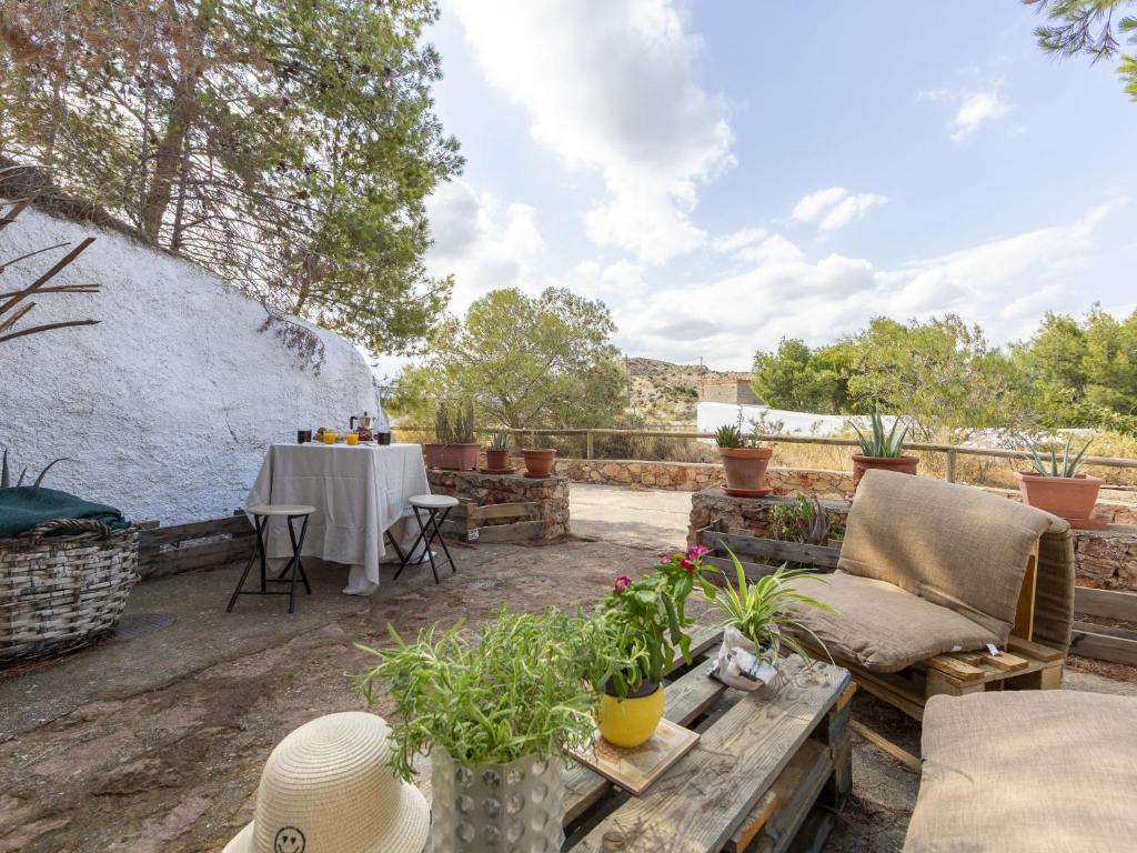 a patio with a couch and a table with plants at Holiday Home Cueva Mariana Pineda by Interhome in Terque