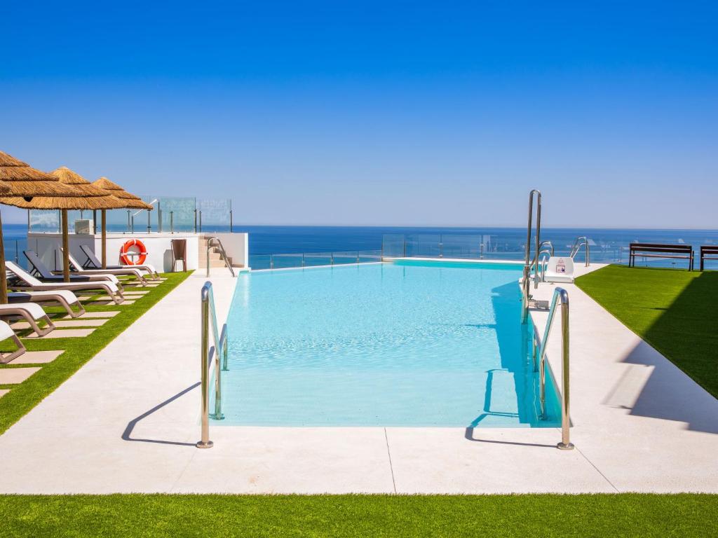 a swimming pool with a view of the ocean at Apartment Heaven Free Spa & Padel by Interhome in Torrox Costa