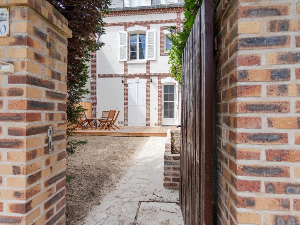an entrance to a house with a brick wall at Holiday Home Maison de ville by Interhome in Deauville