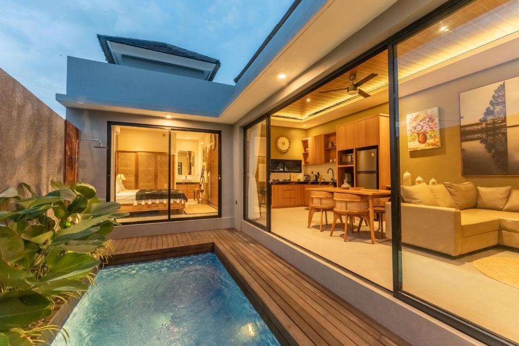 an indoor swimming pool in the middle of a house at Villa Sattvika in Kerobokan