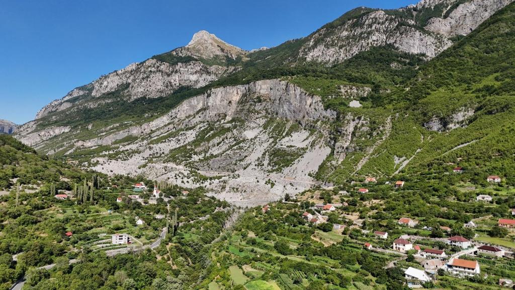 Remote alpine village beneath limestone mountains