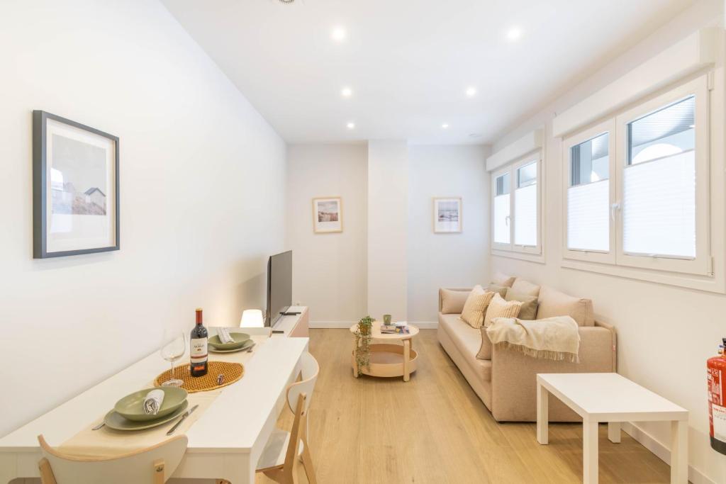 a living room with a couch and a table at Acogedor Loft a 15 minutos del centro de Pamplona in Pamplona