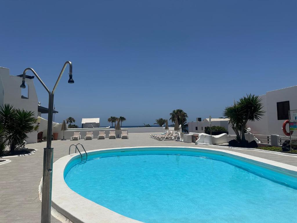 a large swimming pool in a resort at Sea view with direct access to boulevard in Puerto del Carmen