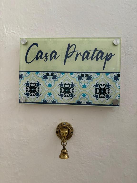 a sign that reads casa piracy hanging on a wall at Casa Pratap in Patna