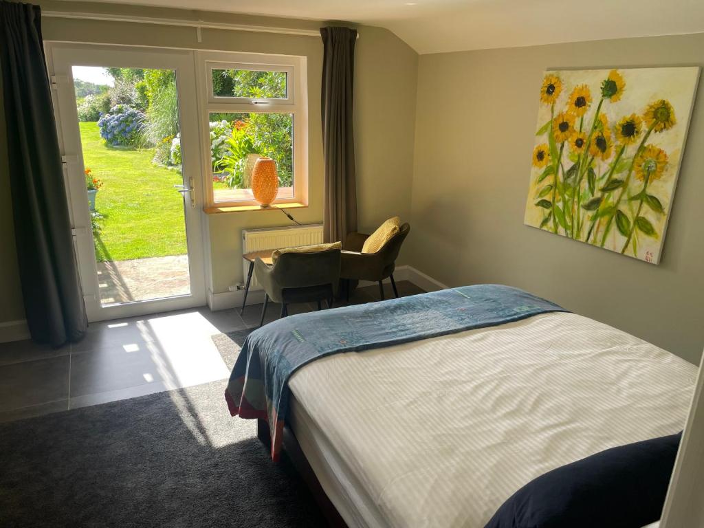 a bedroom with a bed and a desk and a window at Ard na Muirí - Durrus - Apartment in Durrus