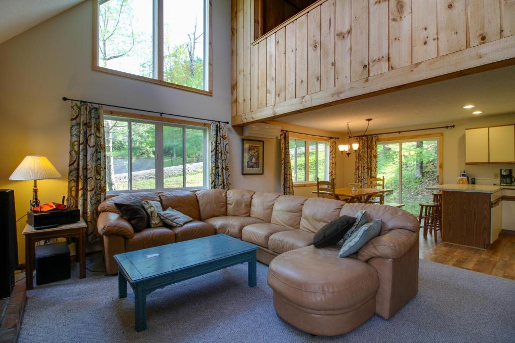 a living room with a couch and a table at Spacious Home Adjacent to Mt Snow with Game Room! in West Dover
